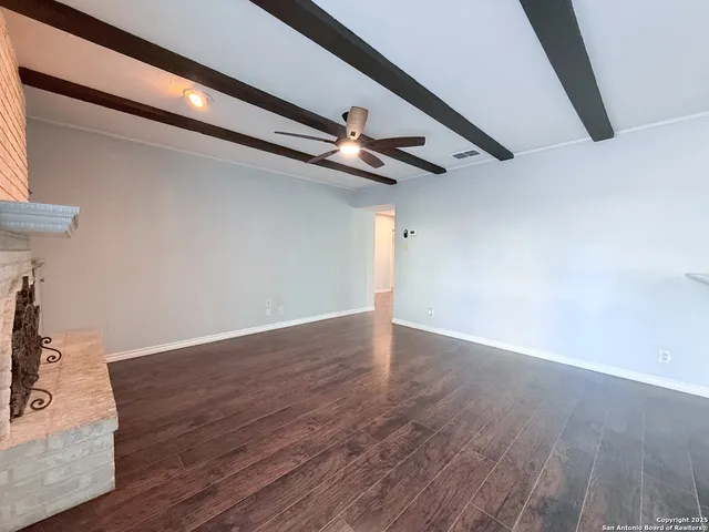 a view of a room with wooden floor