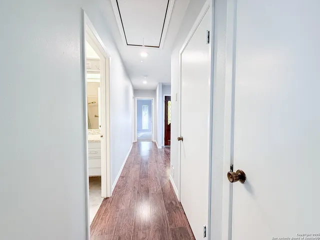 a view of hallway with wooden floor