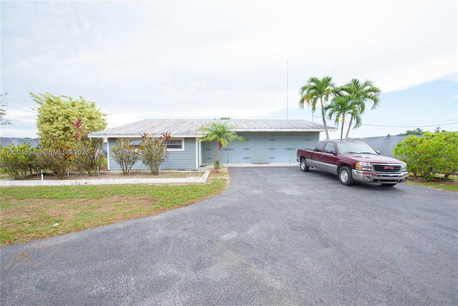 17355 Southwest 256th Street Homestead, FL 33031 - Photo 4 of 32 a house view with a garden space