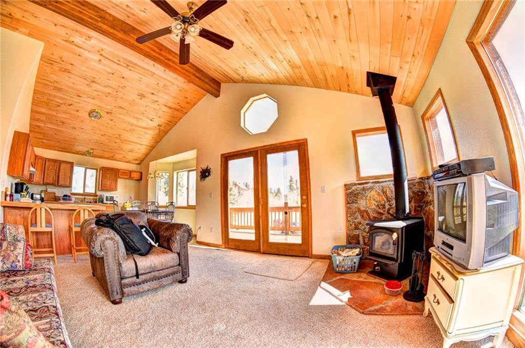 1257 Chippewa Road Como, CO 80456 - Photo 11 of 25 a living room with furniture a flat screen tv and a floor to ceiling window
