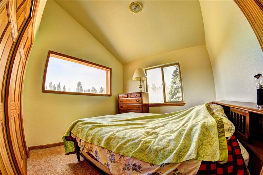1257 Chippewa Road Como, CO 80456 - Photo 16 of 25 a bed sitting in a bedroom next to a window
