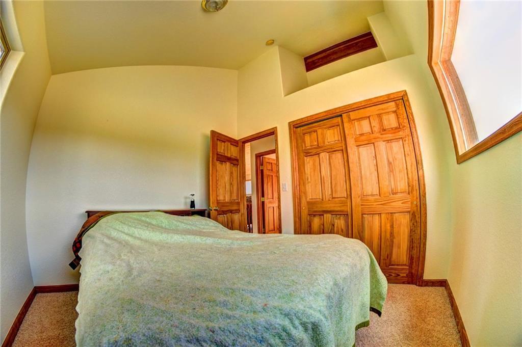 1257 Chippewa Road Como, CO 80456 - Photo 17 of 25 a bed sitting in a bedroom next to a window
