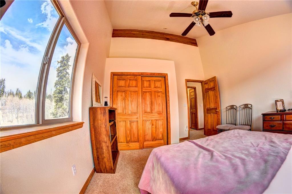 1257 Chippewa Road Como, CO 80456 - Photo 20 of 25 a bedroom with a bed and a chandelier