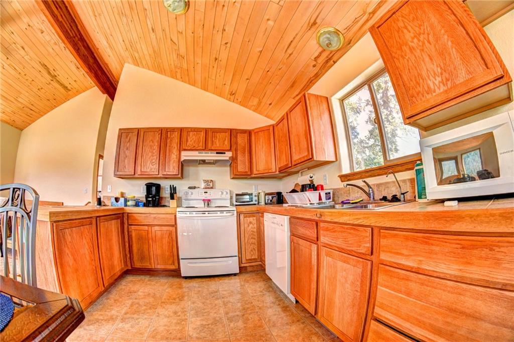 1257 Chippewa Road Como, CO 80456 - Photo 4 of 25 a large kitchen with stainless steel appliances granite countertop a stove a sink and dishwasher
