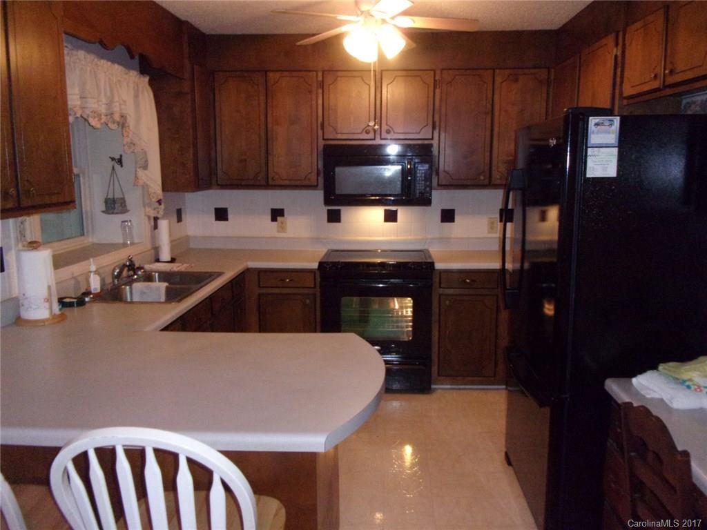 36074 Finger Road, Unit 2 Mount Pleasant, NC 28124 - Photo 13 of 21 a kitchen with stainless steel appliances a sink a stove a microwave a refrigerator and cabinets