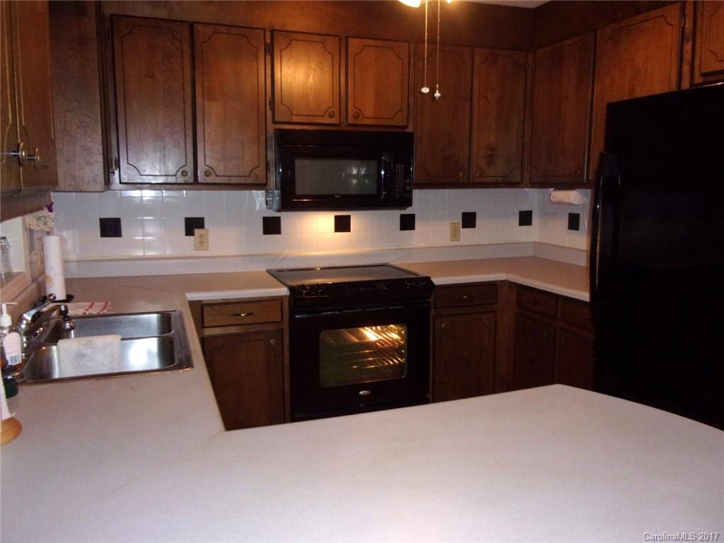 36074 Finger Road, Unit 2 Mount Pleasant, NC 28124 - Photo 14 of 21 a kitchen with stainless steel appliances granite countertop a stove a refrigerator and a microwave