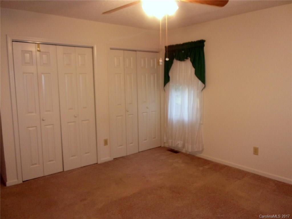 36074 Finger Road, Unit 2 Mount Pleasant, NC 28124 - Photo 10 of 21 an empty room with a chandelier fan