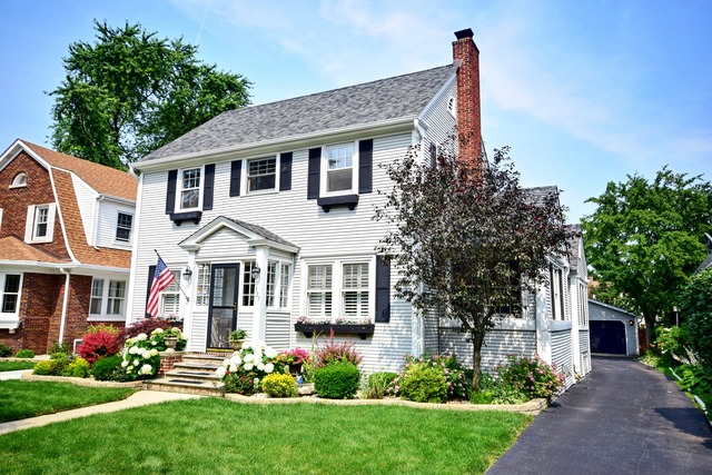 323 North Merrill Street Park Ridge, IL 60068 - Photo 1 of 25 a front view of a house with a garden and plants
