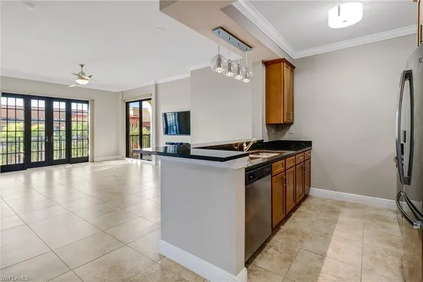 a kitchen with stainless steel appliances a refrigerator and a stove top oven
