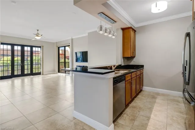 a kitchen with stainless steel appliances a refrigerator and a stove top oven