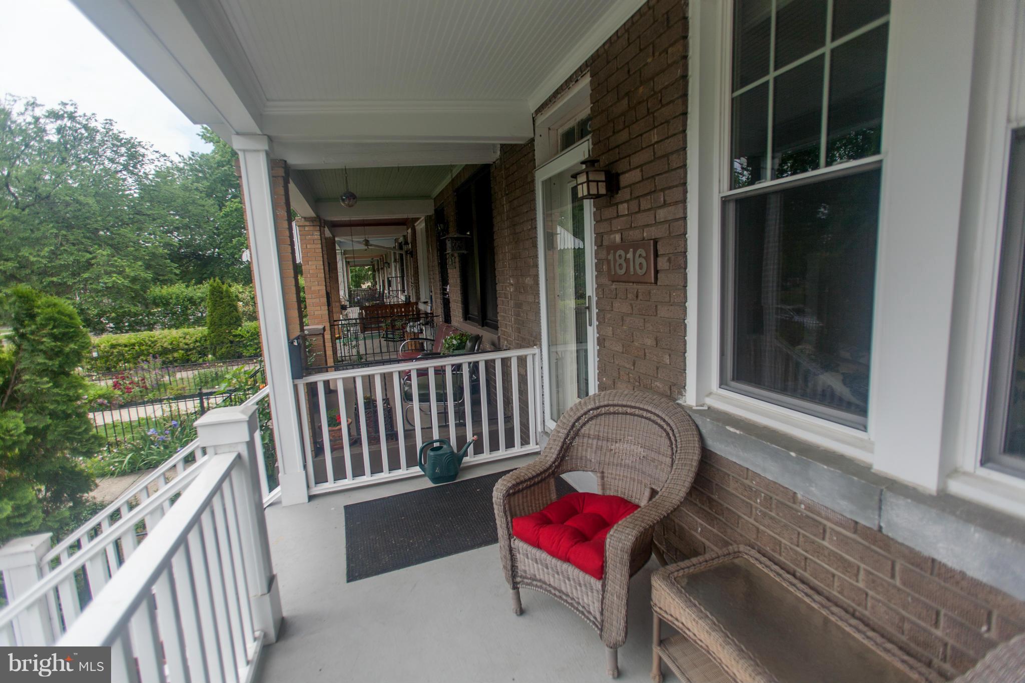 a view of a balcony with chair and wooden floor