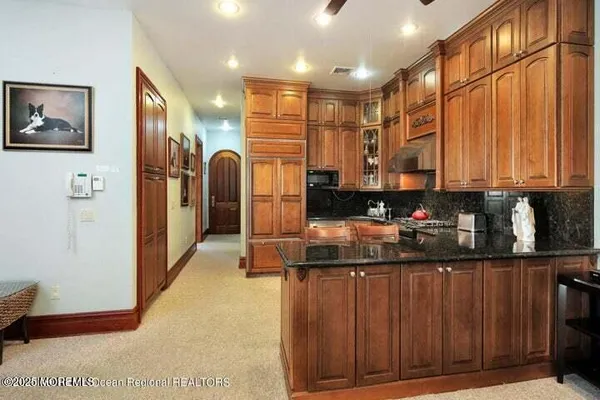 a kitchen with stainless steel appliances granite countertop a refrigerator and a sink