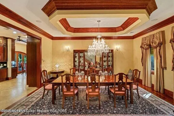 a view of a dining room with furniture and chandelier