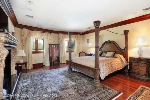 a bedroom with a bed and a mirror