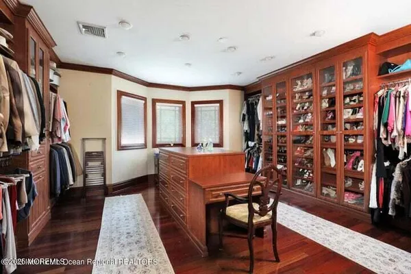 a very nice looking room with many windows and furniture