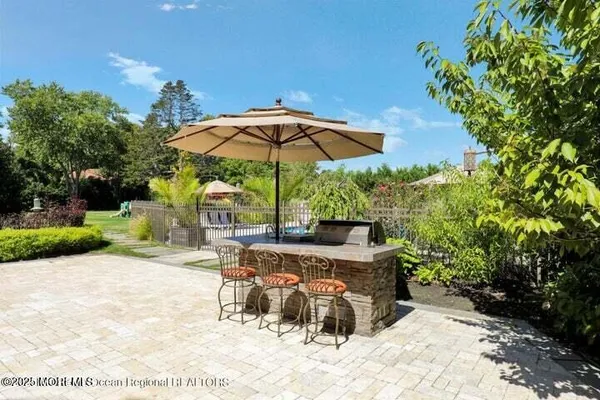 a view of a patio with a table and chairs under an umbrella