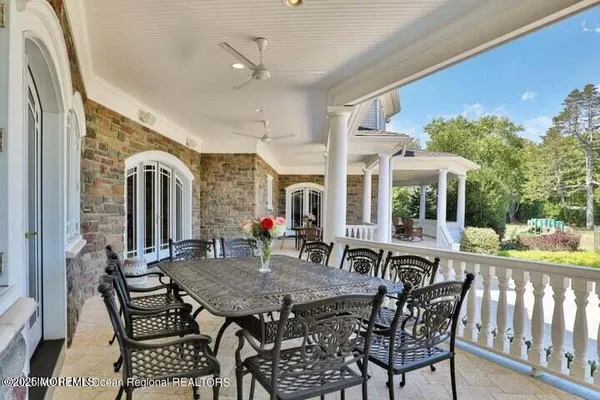 a view of a patio with table and chairs and potted plants