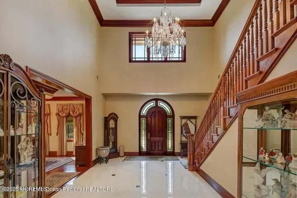 a view of staircase with railing and a chandelier