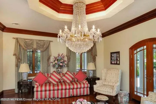 a bedroom with furniture and chandelier