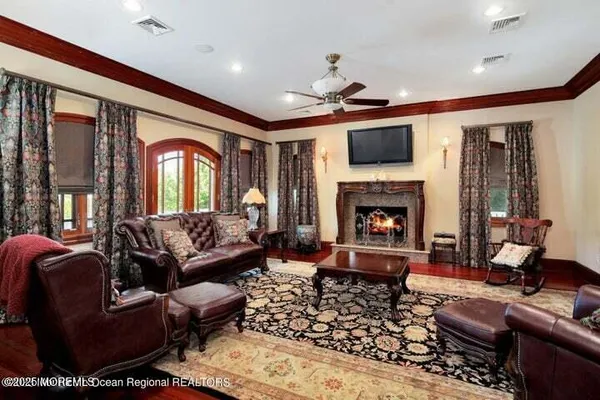 a living room with furniture a flat screen tv and a fireplace
