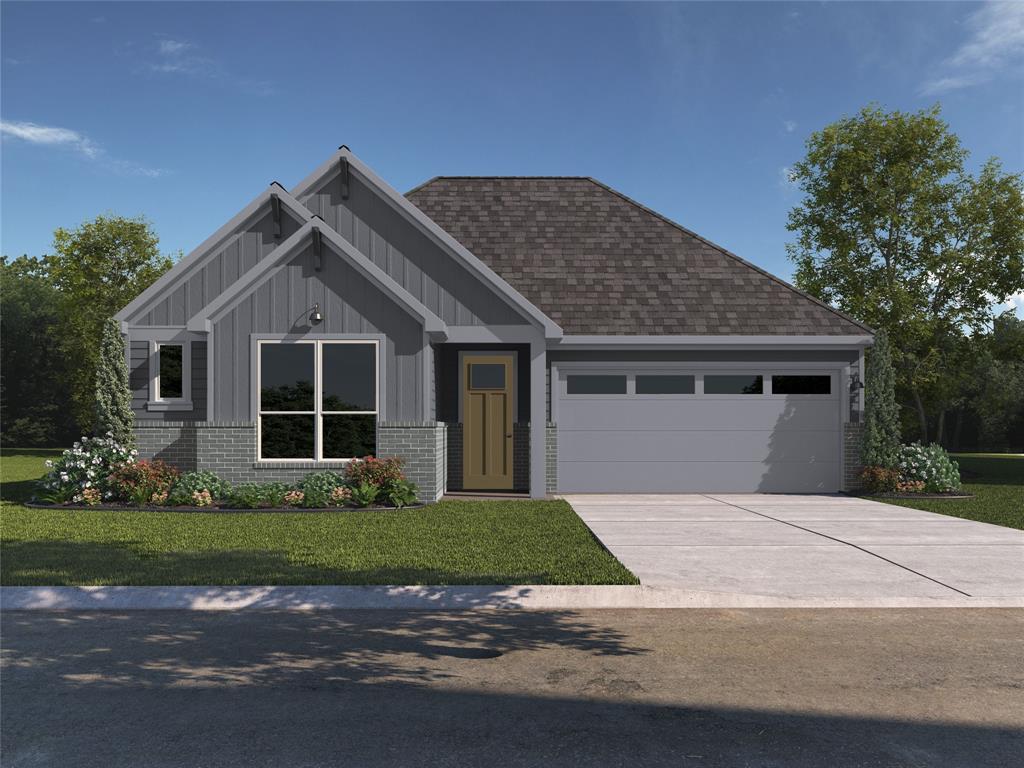 a front view of a house with a garden and yard