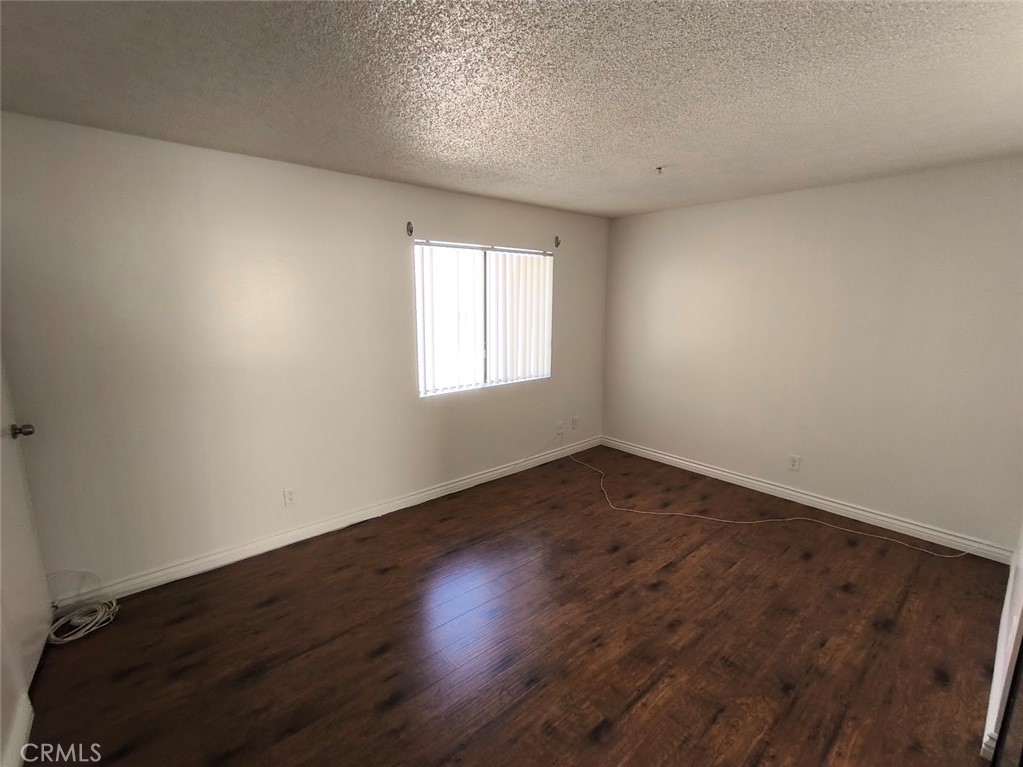 125 North 3rd Street, Unit D Alhambra, CA 91801 - Photo 11 of 16 an empty room with wooden floor and windows
