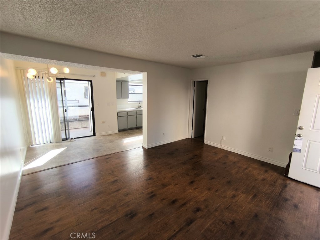 125 North 3rd Street, Unit D Alhambra, CA 91801 - Photo 2 of 16 an empty room with wooden floor and windows