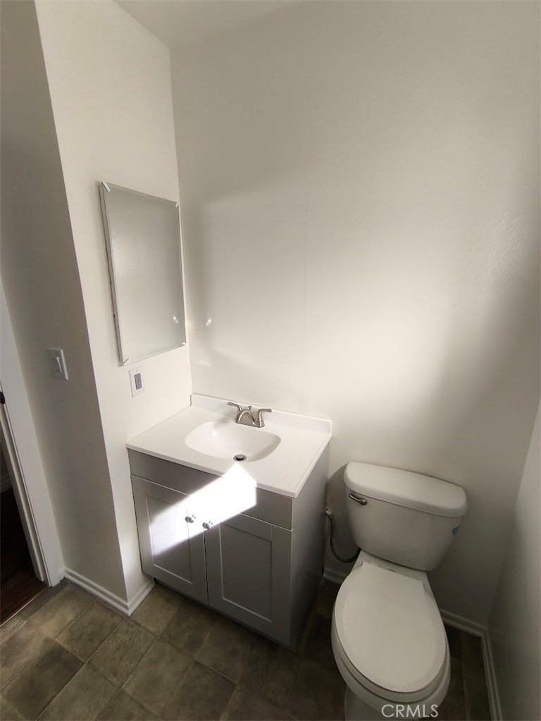 125 North 3rd Street, Unit D Alhambra, CA 91801 - Photo 9 of 16 a white toilet sitting next to a bathroom sink