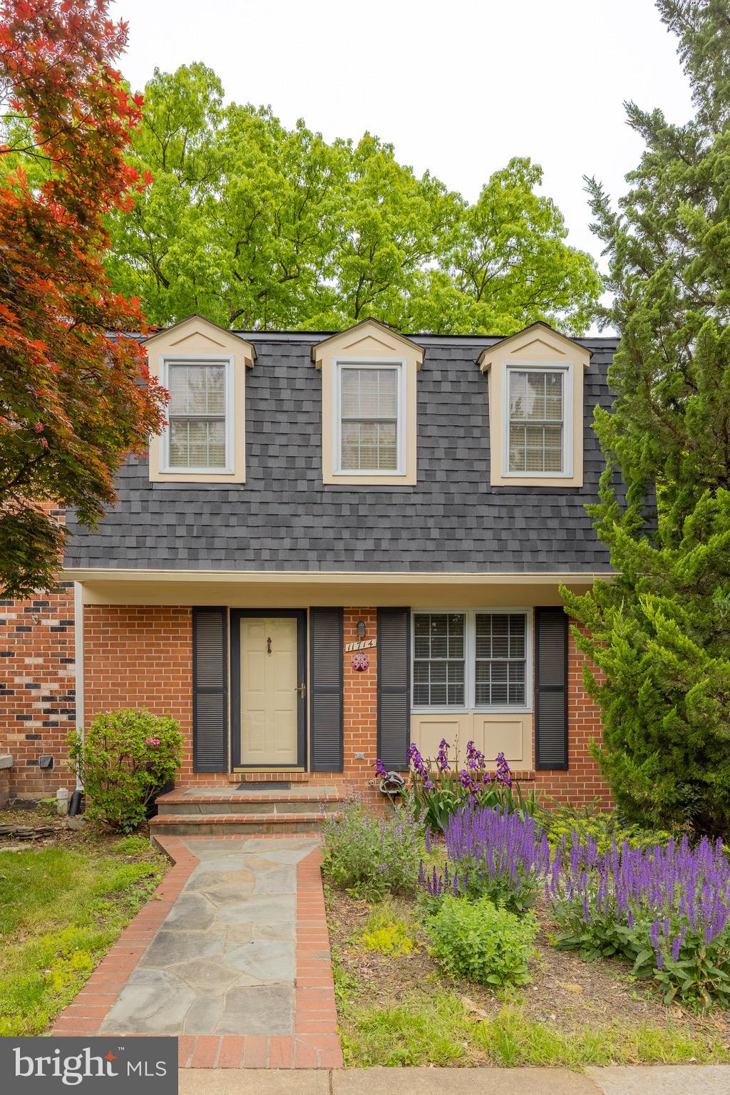 11714 Dry River Court Reston, VA 20191 - Photo 1 of 24 front view of a brick house with a yard
