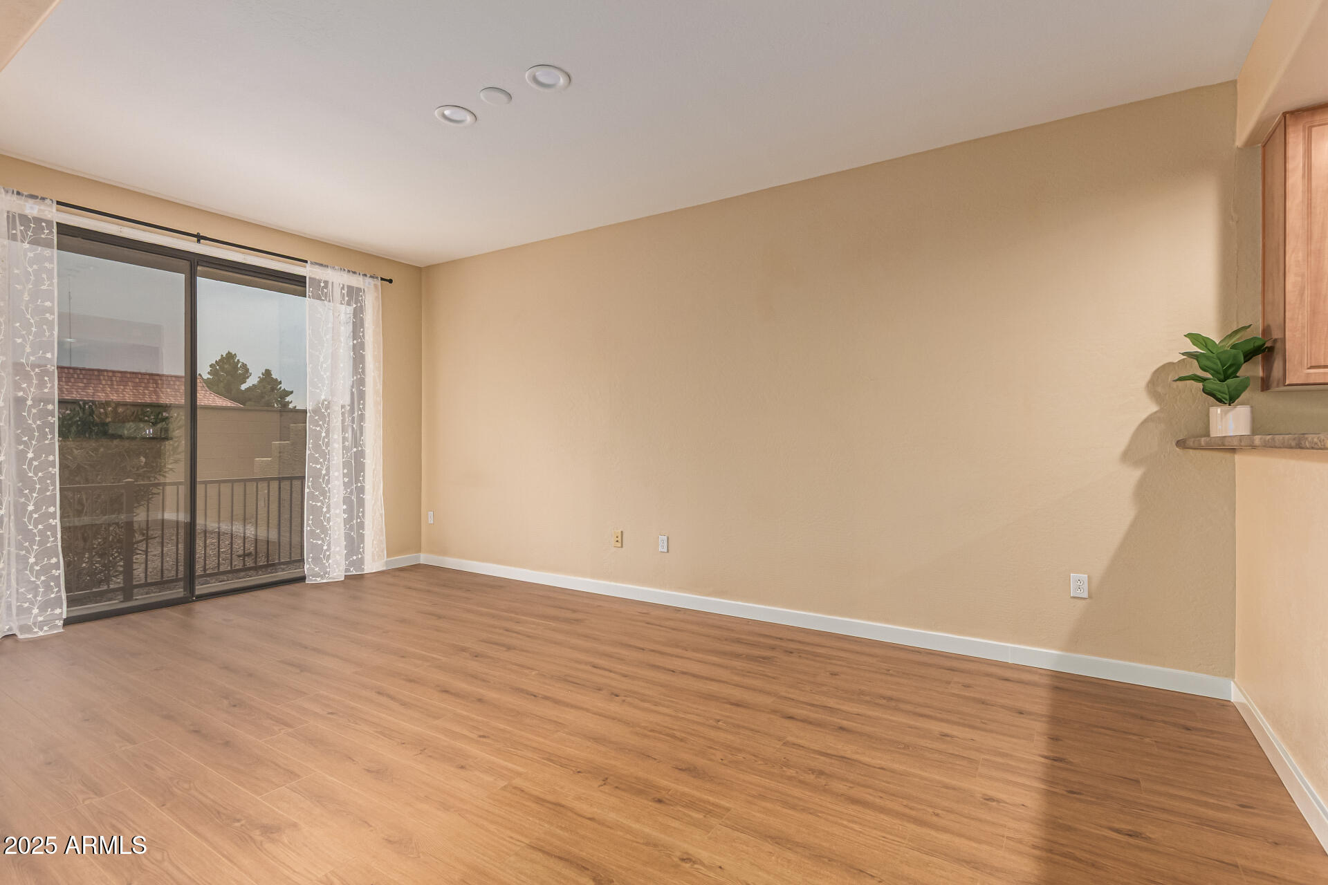 705 West Queen Creek Road, Unit 1201 Chandler, AZ 85248 - Photo 10 of 51 a view of an empty room with wooden floor