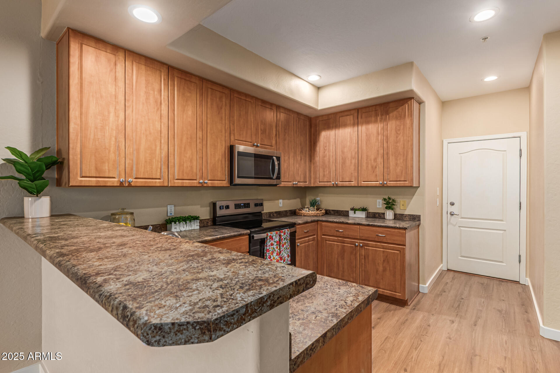 705 West Queen Creek Road, Unit 1201 Chandler, AZ 85248 - Photo 12 of 51 a kitchen with granite countertop wooden cabinets a stove top oven a sink and dishwasher