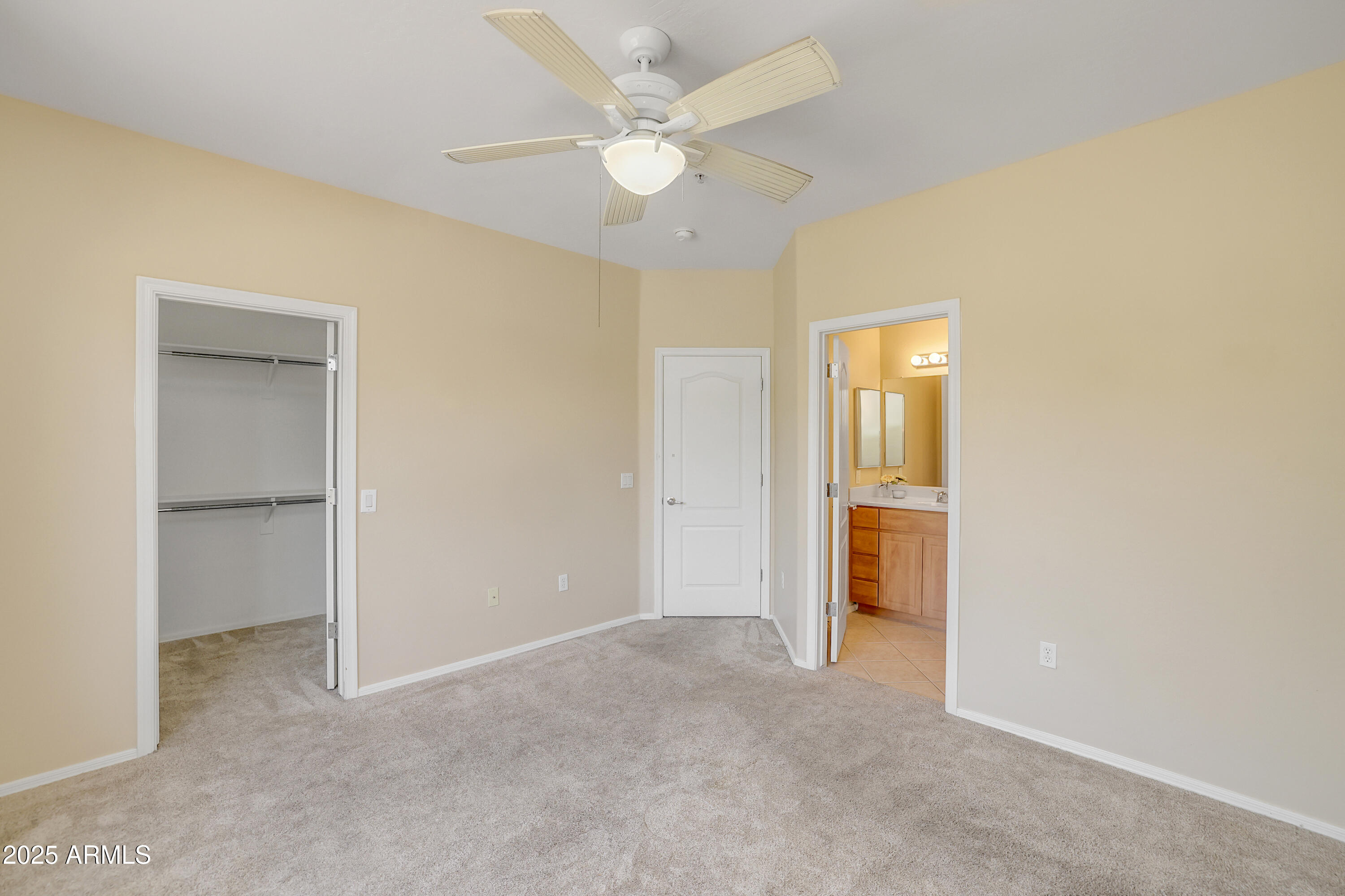 705 West Queen Creek Road, Unit 1201 Chandler, AZ 85248 - Photo 26 of 51 an empty room with a ceiling fan and a bathroom