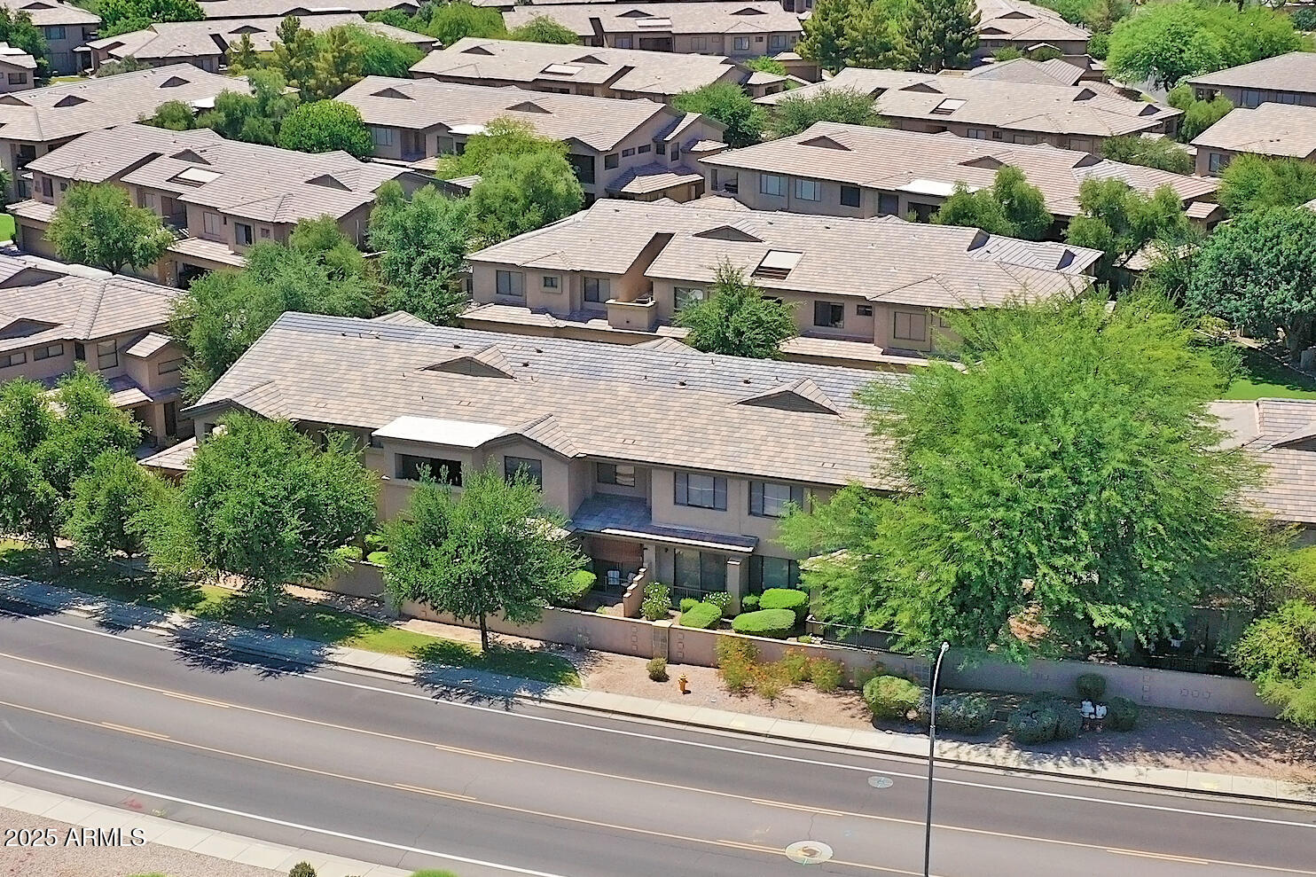 705 West Queen Creek Road, Unit 1201 Chandler, AZ 85248 - Photo 44 of 51 an aerial view of multiple houses with a yard