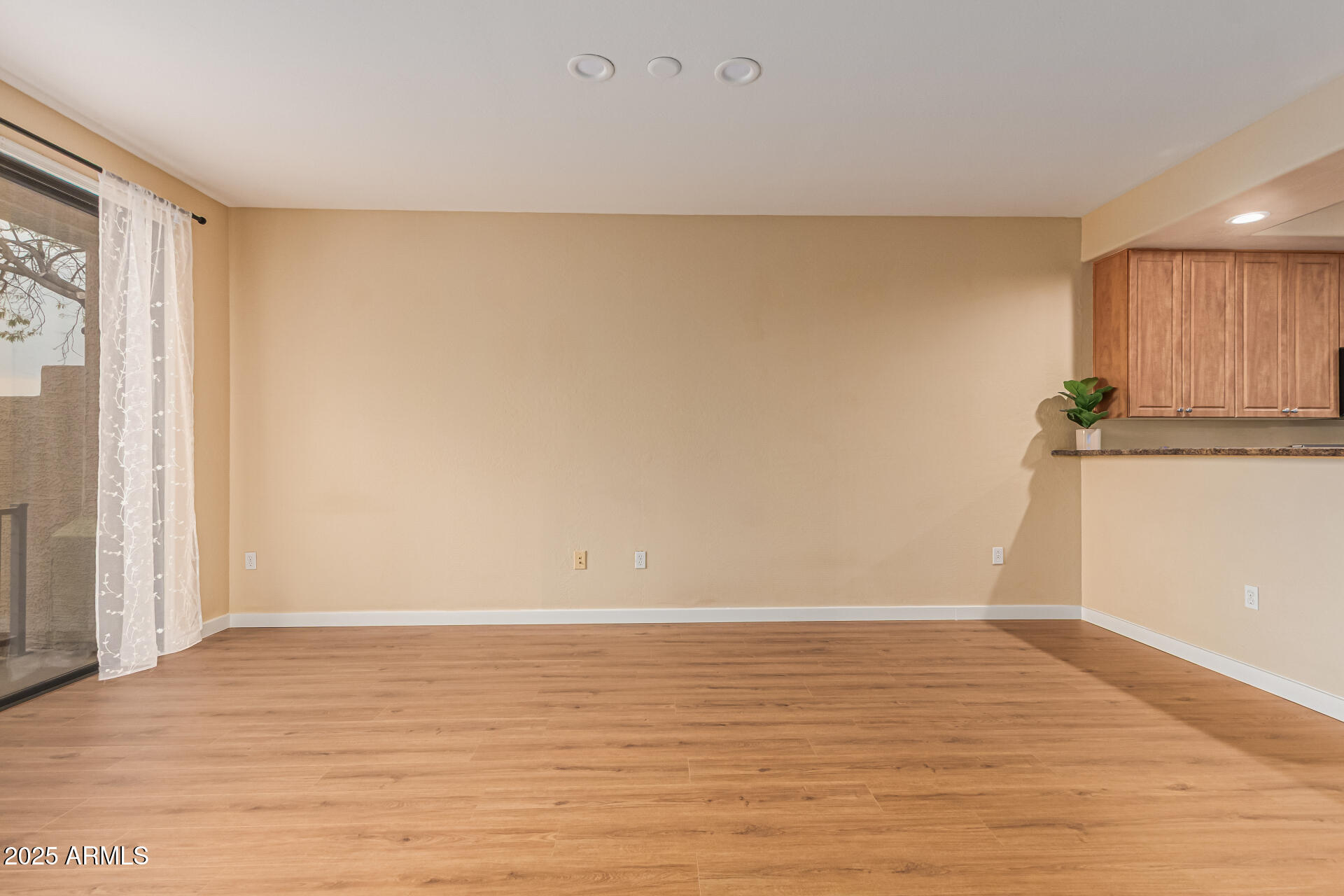 705 West Queen Creek Road, Unit 1201 Chandler, AZ 85248 - Photo 5 of 51 a view of an empty room with wooden floor and a window