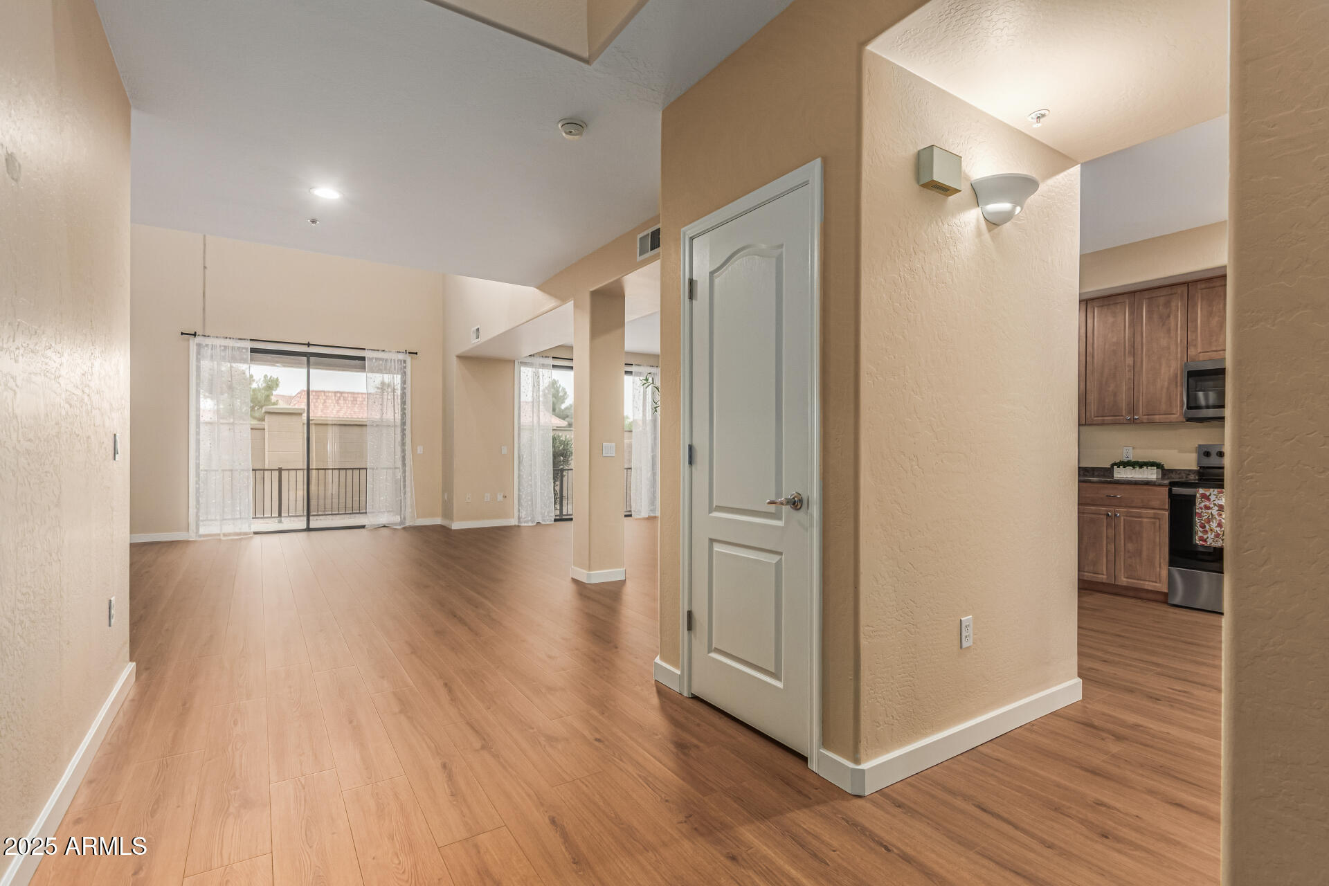 705 West Queen Creek Road, Unit 1201 Chandler, AZ 85248 - Photo 7 of 51 a view of a hallway with wooden floor and a living room