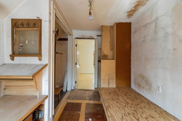a view of a hallway view with wooden floor and staircase