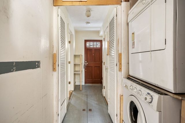 a view of a hallway with washer and dryer