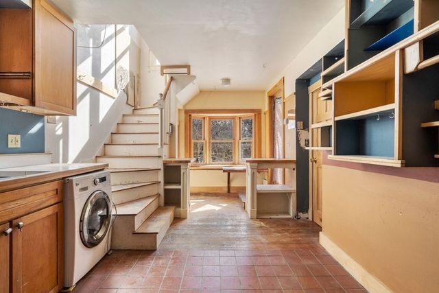 a view of a hallway with washer and dryer