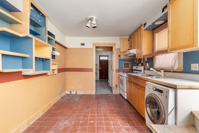 a view of a kitchen with a sink and a refrigerator