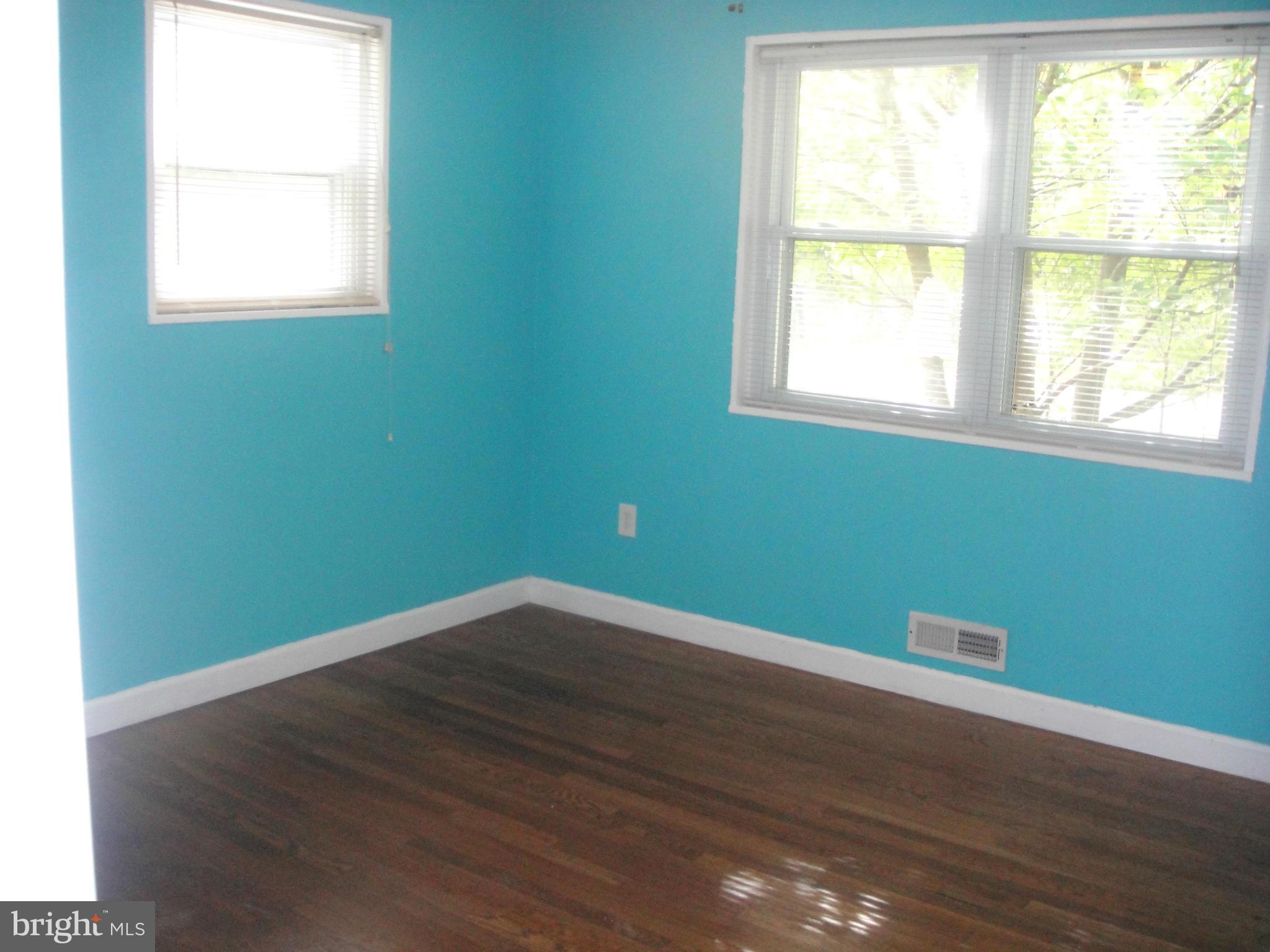 3701 Kayson Street Silver Spring, MD 20906 - Photo 14 of 30 an empty room with wooden floor and windows