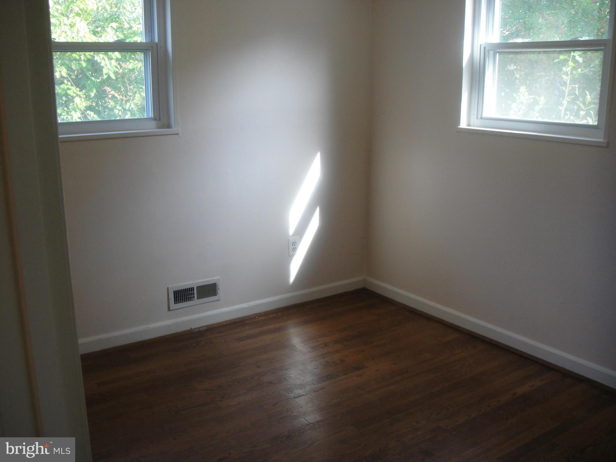 3701 Kayson Street Silver Spring, MD 20906 - Photo 15 of 30 an empty room with wooden floor and windows