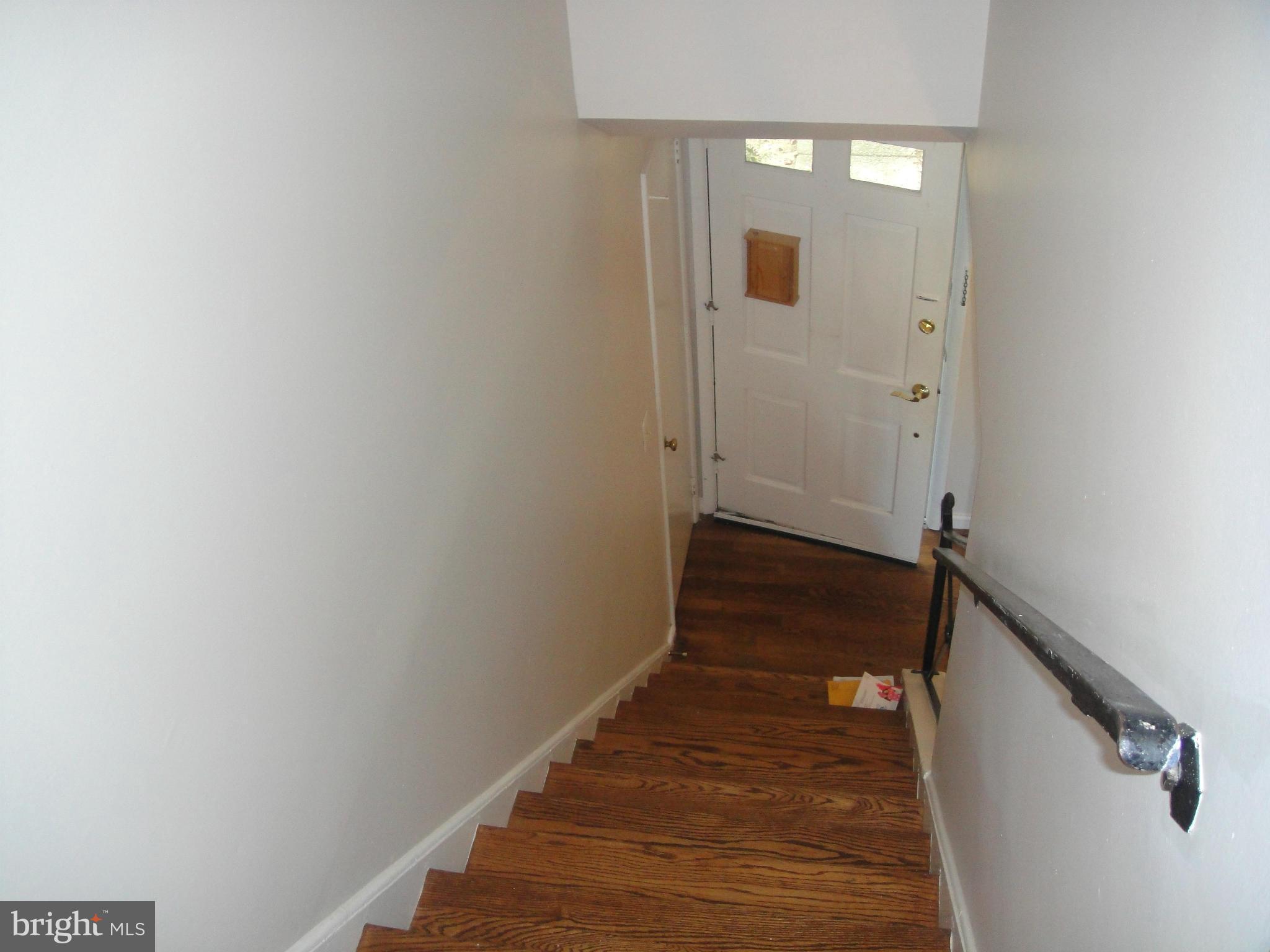 3701 Kayson Street Silver Spring, MD 20906 - Photo 16 of 30 a view of a hallway with wooden floor and staircase