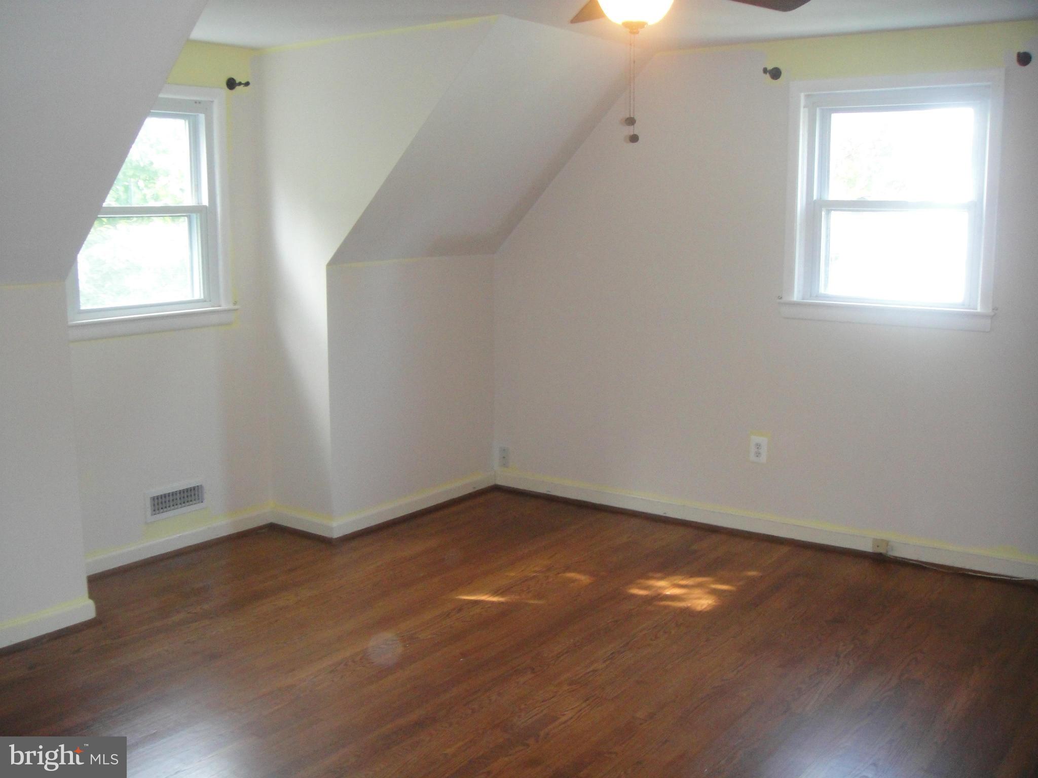3701 Kayson Street Silver Spring, MD 20906 - Photo 17 of 30 an empty room with wooden floor and windows