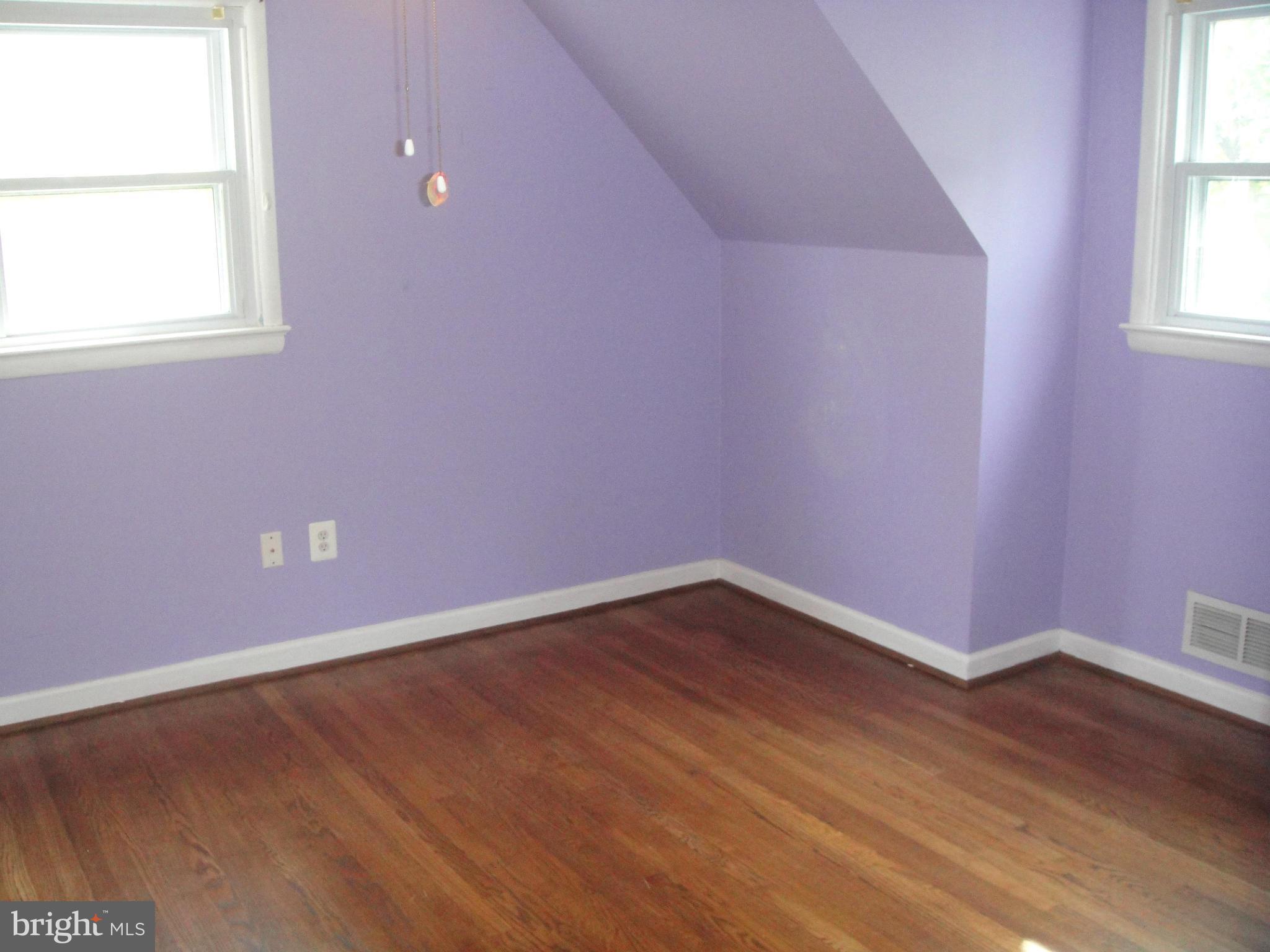 3701 Kayson Street Silver Spring, MD 20906 - Photo 19 of 30 an empty room with wooden floor and windows