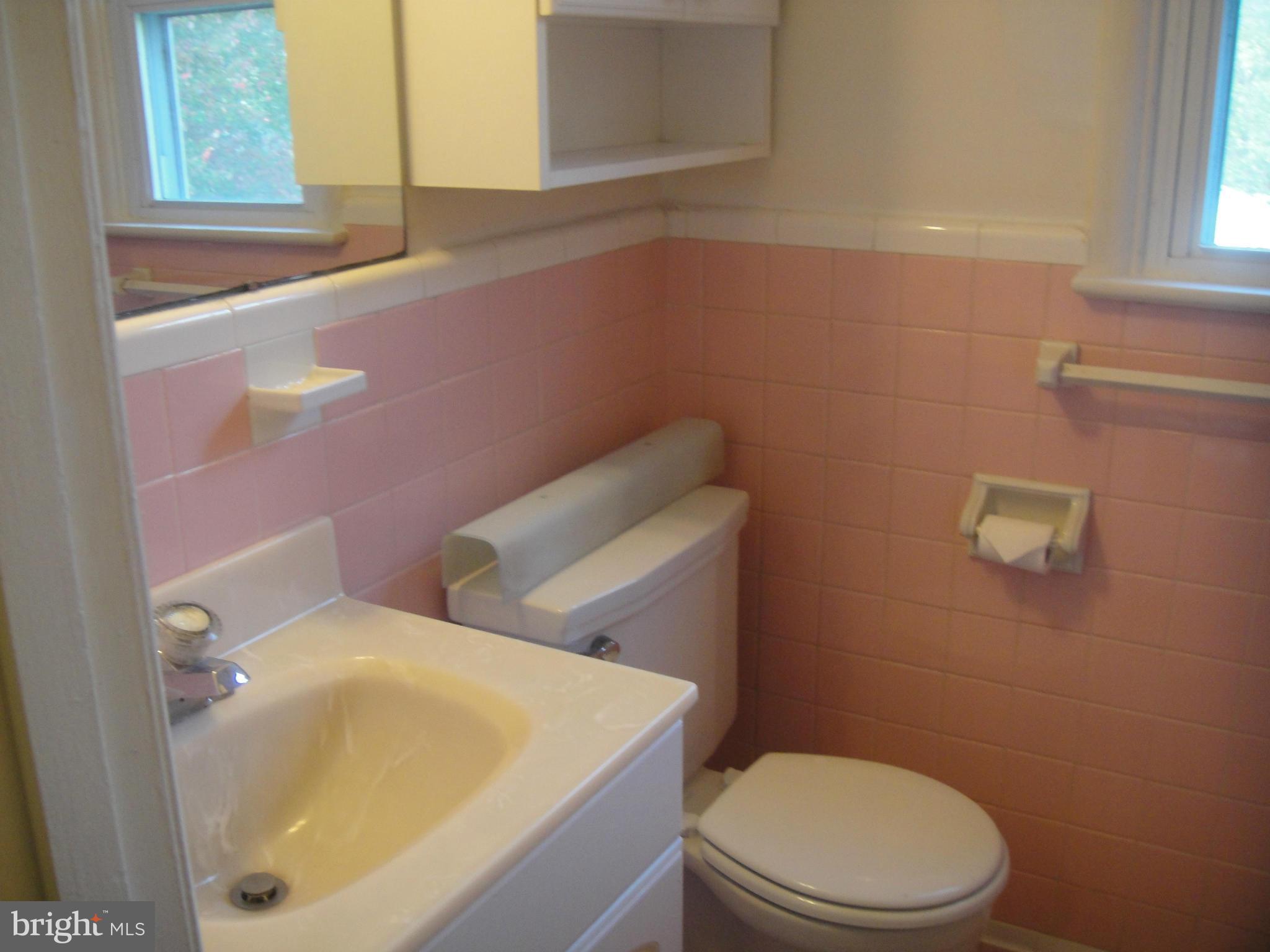 3701 Kayson Street Silver Spring, MD 20906 - Photo 21 of 30 a bathroom with a sink a toilet and a mirror