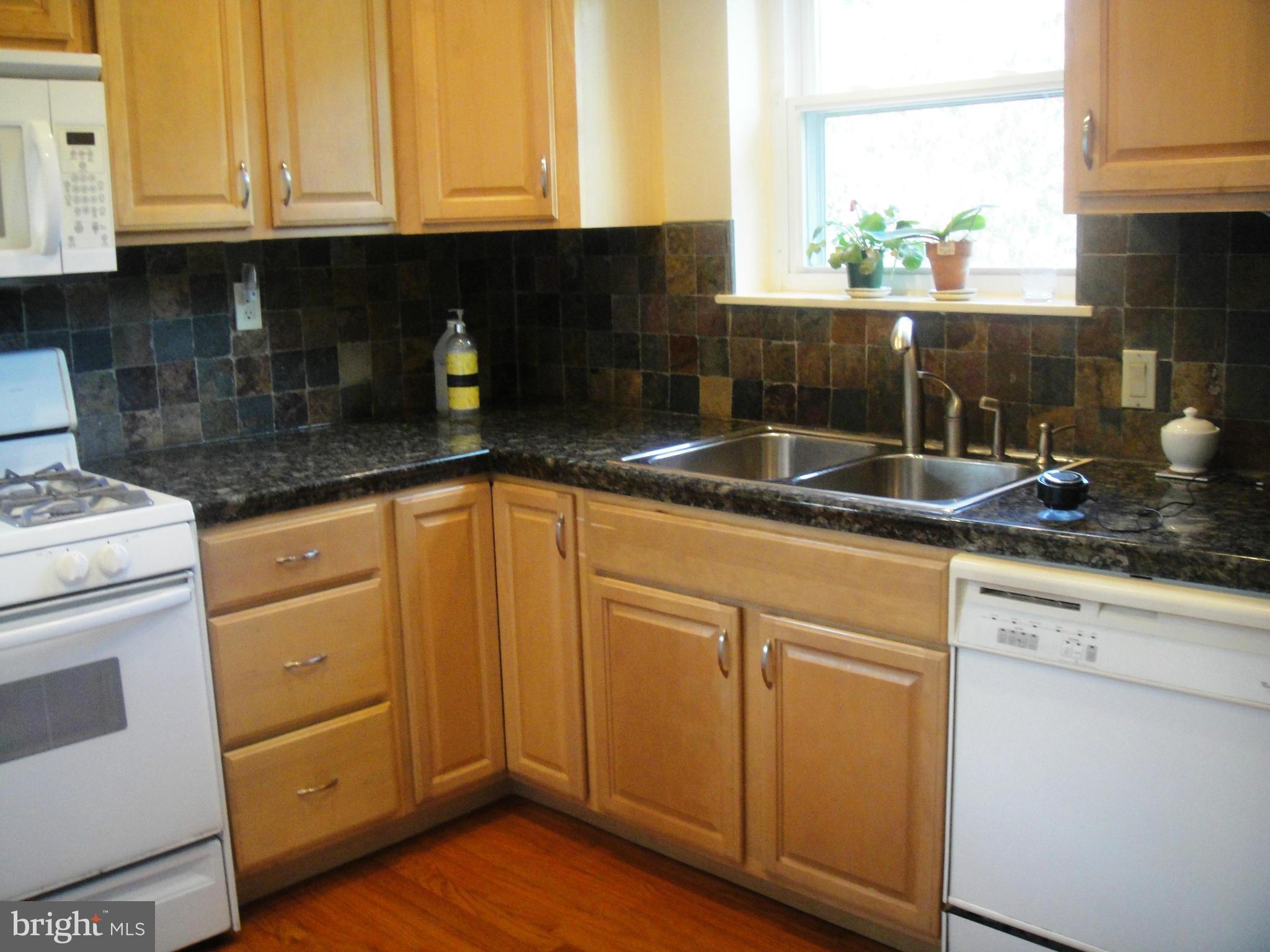 3701 Kayson Street Silver Spring, MD 20906 - Photo 6 of 30 a kitchen with granite countertop a sink a stove and cabinets
