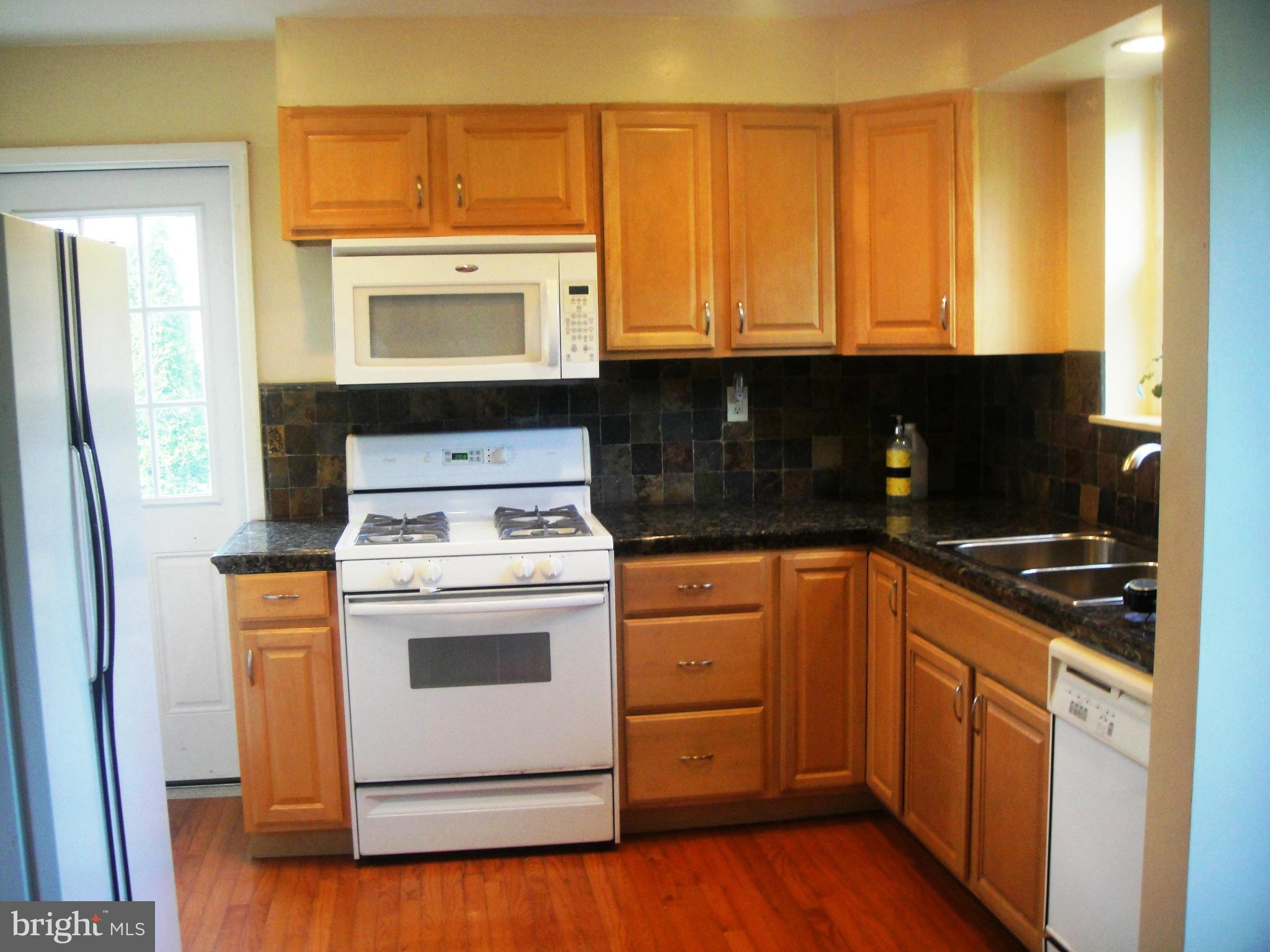 3701 Kayson Street Silver Spring, MD 20906 - Photo 7 of 30 a kitchen with a stove top oven sink and cabinets