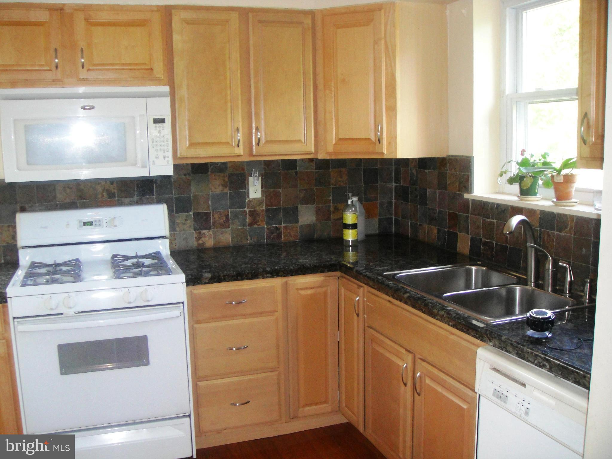 3701 Kayson Street Silver Spring, MD 20906 - Photo 9 of 30 a kitchen with granite countertop white cabinets and white appliances