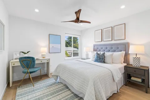 a bathroom with a granite countertop sink a toilet and a mirror