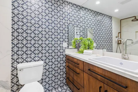 a white toilet sitting next to a shower curtain